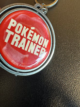 Load image into Gallery viewer, Bioworld 2016 Pokemon Trainer Spinning Metal Keychain
